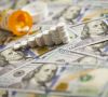 Medicine Pills Stacked Like Increasing Graph on Newly Designed U.S. One Hundred Dollar Bills.